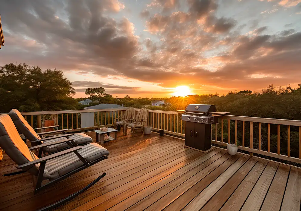 beautiful deck with lounge chairs and just in front of a sunset