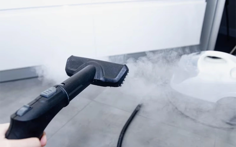 Steam cleaner cleaning a ceramic floor floor