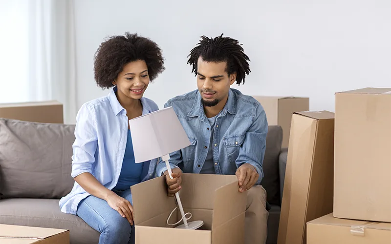 Couple moving house, with some moving boxes