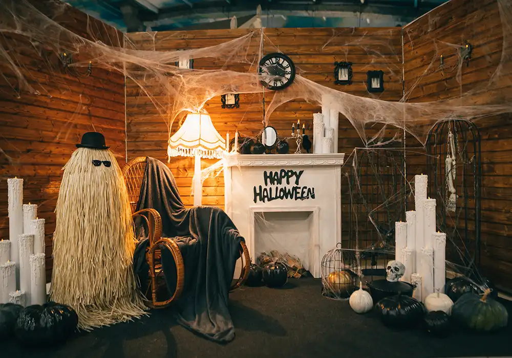House with Halloween decorations, webs on the ceiling, toy ghosts, skulls and pumpkins, happy Halloween written on the wall